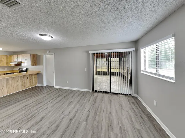 a view of a kitchen with wooden floor and a sink