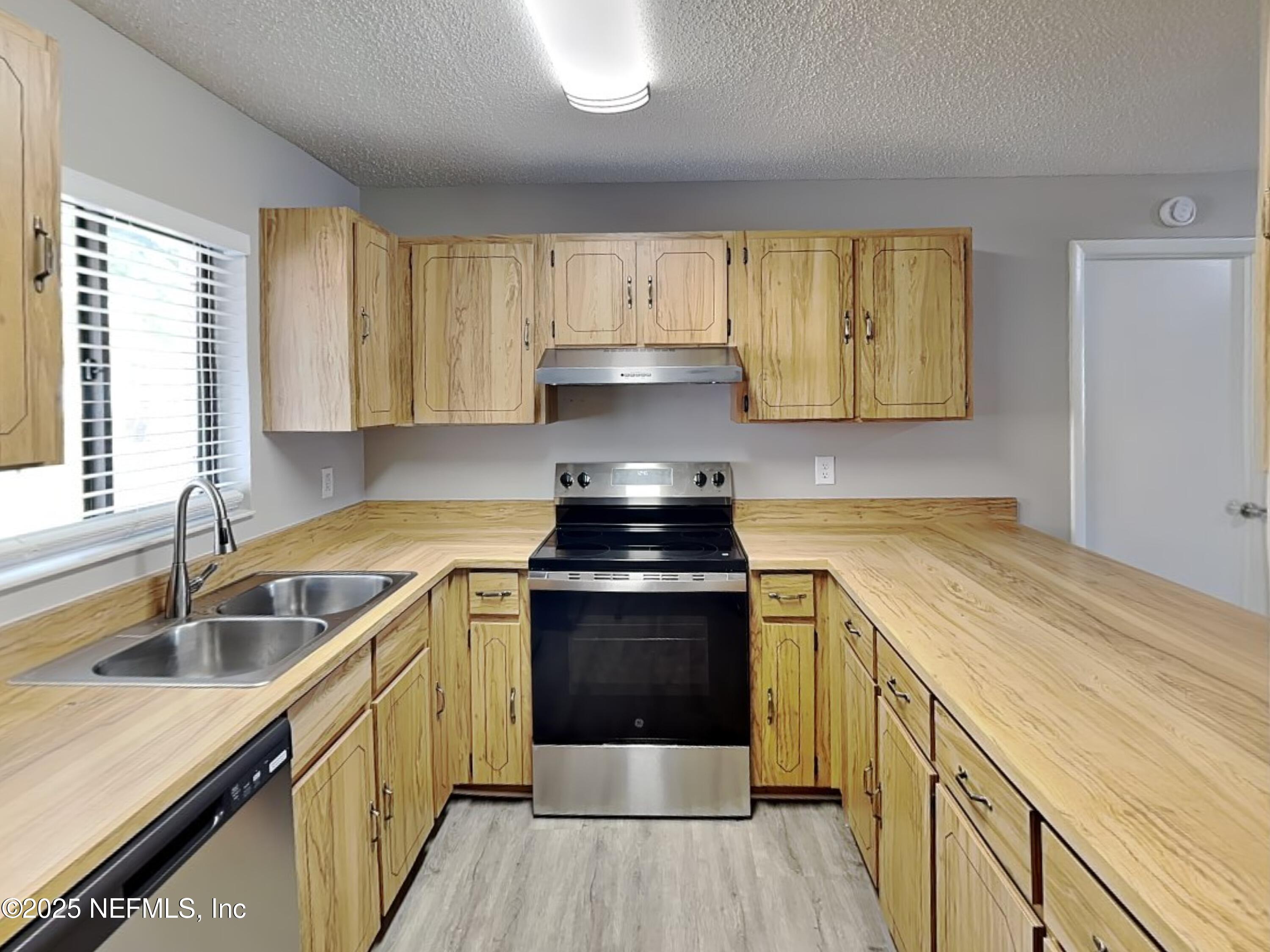 31 Folson Lane Palm Coast, FL 32137 - Photo 6 of 15 a kitchen with a stove sink and cabinets