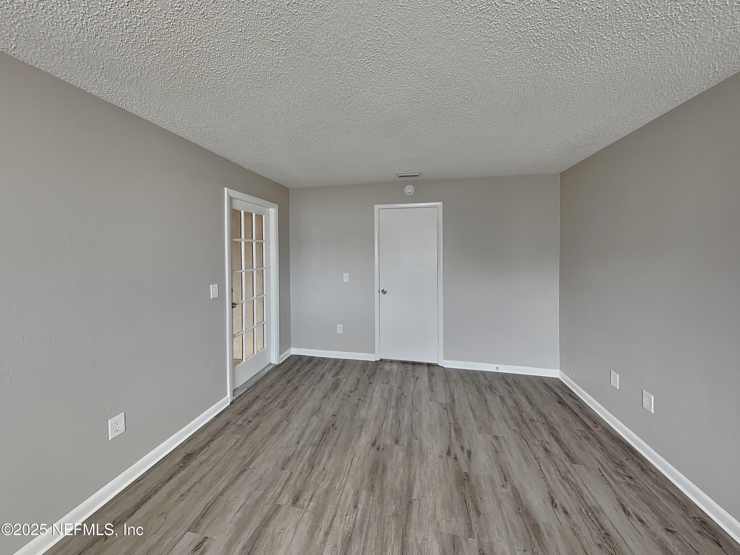 31 Folson Lane Palm Coast, FL 32137 - Photo 7 of 15 a view of an empty room with wooden floor and closet