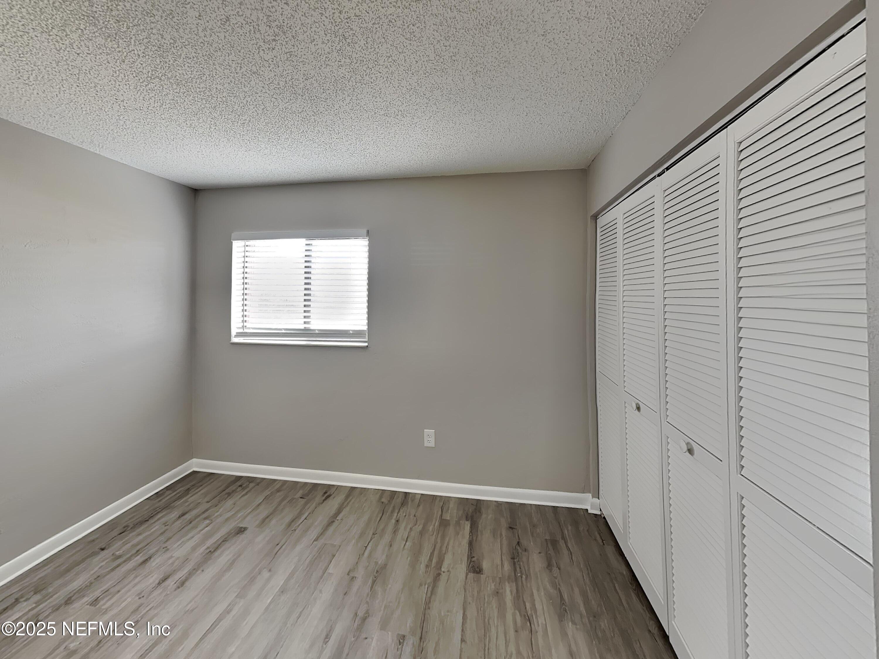 31 Folson Lane Palm Coast, FL 32137 - Photo 9 of 15 wooden floor in an empty room with a window