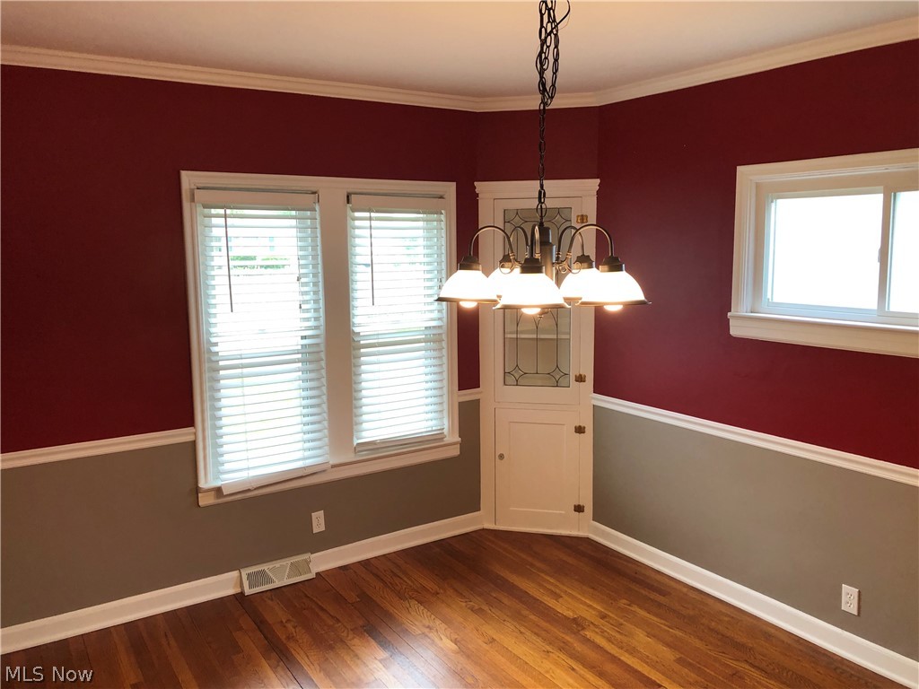 1246 Lander Road Cleveland, OH 44124 - Photo 14 of 26 The charm of this formal dining room is enhanced by the crown molding, chair rail, built-in China cabinets, chandelier, and handsome hardwood floor.
