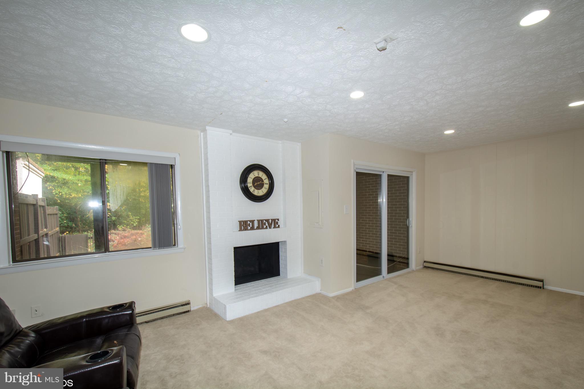 2103 Glencourse Lane Reston, VA 20191 - Photo 25 of 31 Wood Fireplace accents your recroom space