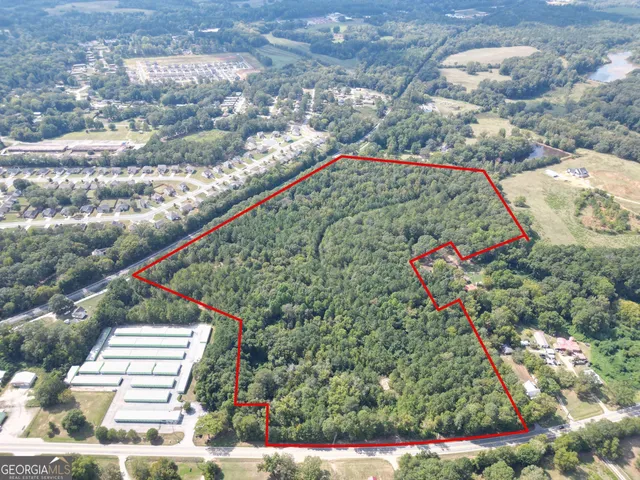 an aerial view of house with yard and mountain view in back