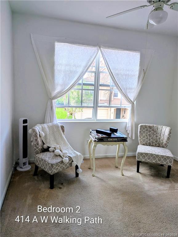 414 Southwest Walking Path, Unit 414 Stuart, FL 34997 - Photo 10 of 15 a living room with furniture and a large window