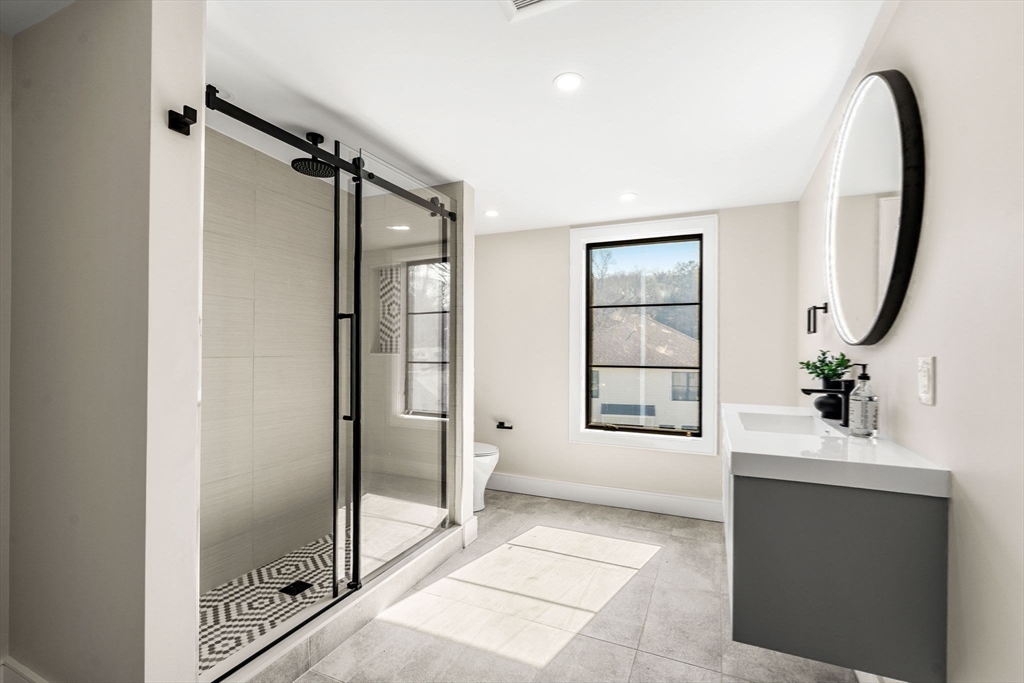 93 Sevland Road Newton, MA 02459 - Photo 24 of 34 a bathroom with a tub shower and mirror