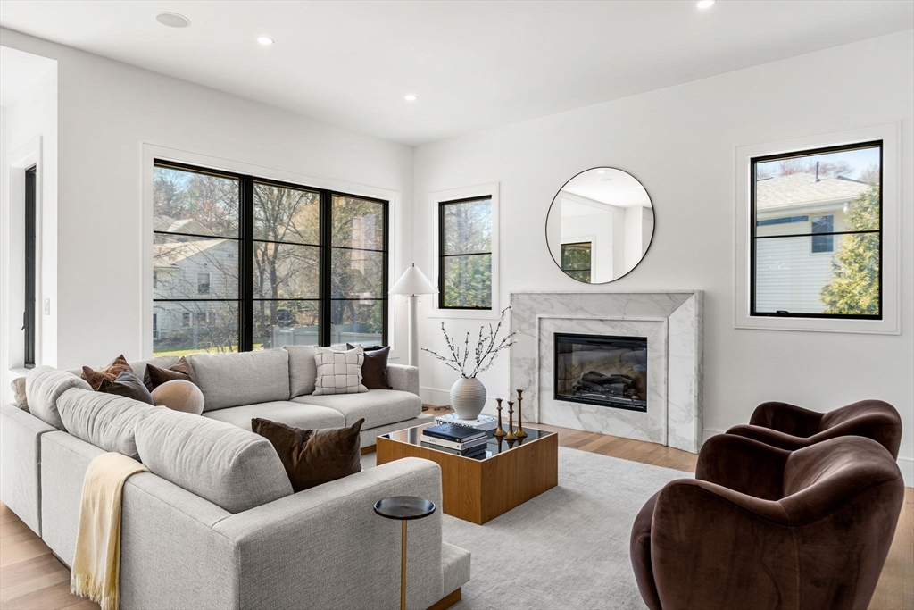 93 Sevland Road Newton, MA 02459 - Photo 7 of 34 a living room with furniture mirror and fireplace