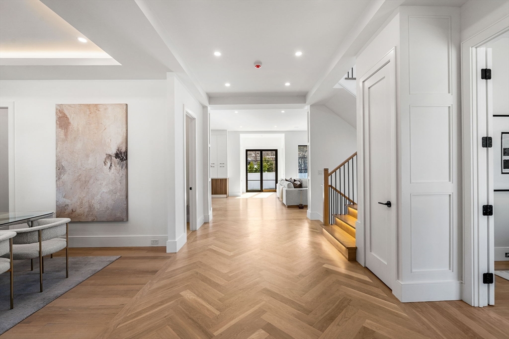 93 Sevland Road Newton, MA 02459 - Photo 9 of 34 a view of a hallway with wooden floor and furniture
