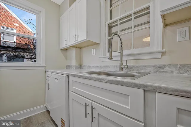 a kitchen with a sink and cabinets