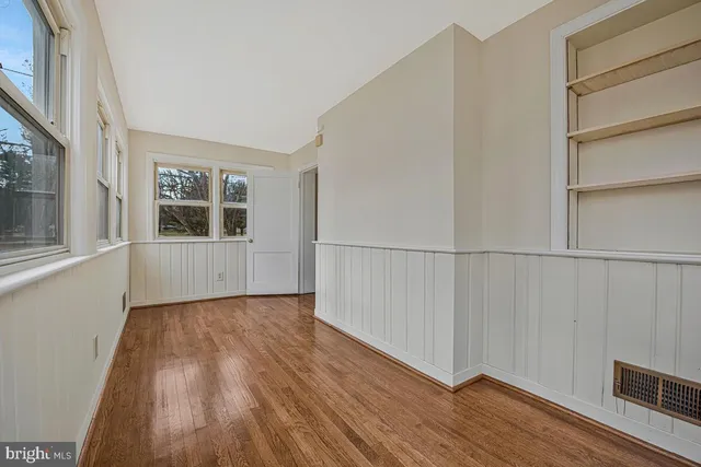 a view of wooden floor and windows in a room