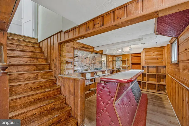 a view of a balcony with wooden floor and brick walls