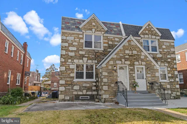 a front view of a residential houses with yard