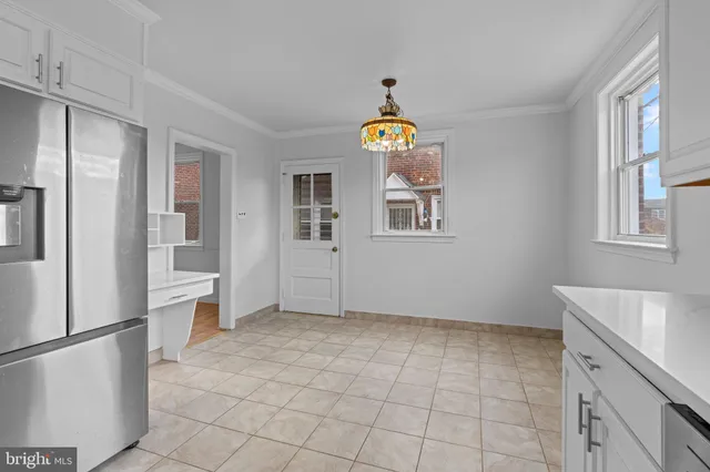 a view of kitchen with stainless steel appliances cabinets and a window