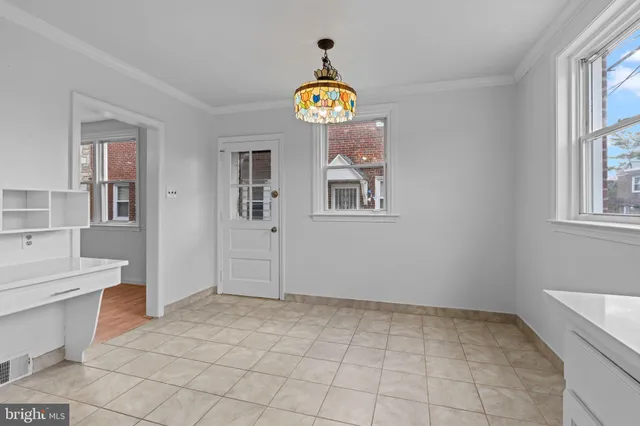 a view of an entryway with wooden floor and a window