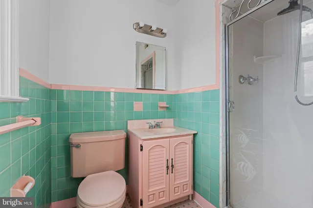 a bathroom with a sink a toilet and a shower