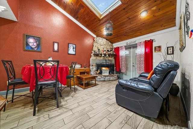 a view of a hallway with wooden floor and a living room