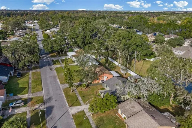 an aerial view of residential houses with outdoor space and swimming pool