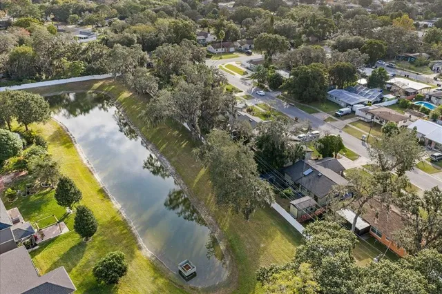 a view of a white house with a yard