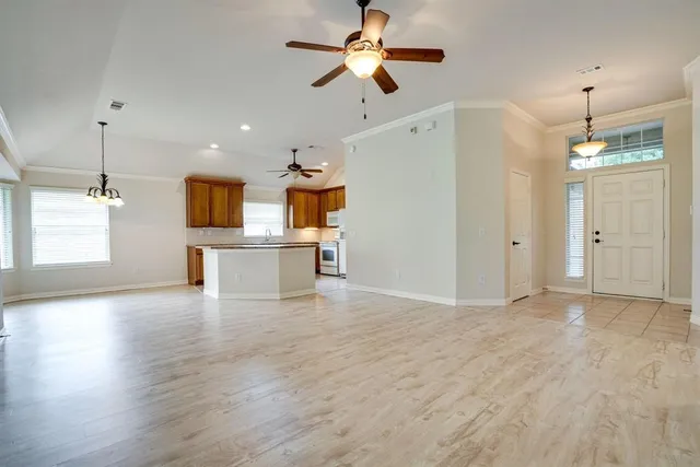 a view of a kitchen with a sink and a chandelier fan