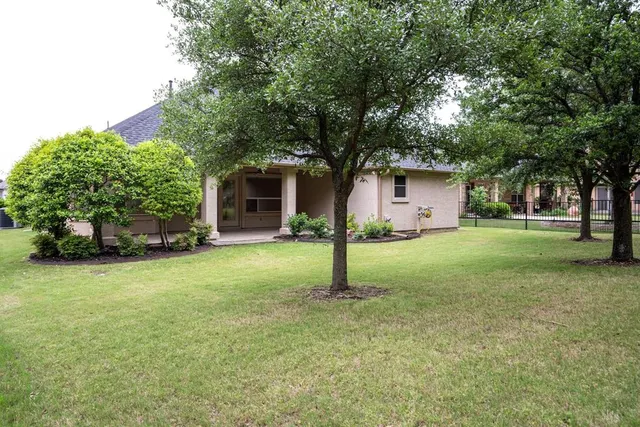 a front view of house with yard and green space