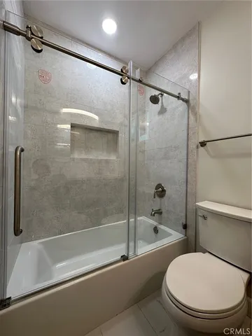 a bathroom with a toilet and a bathtub