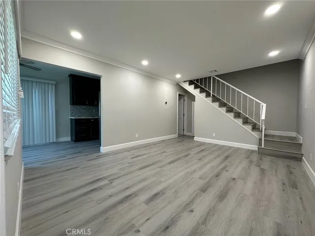 a view of empty room with wooden floor