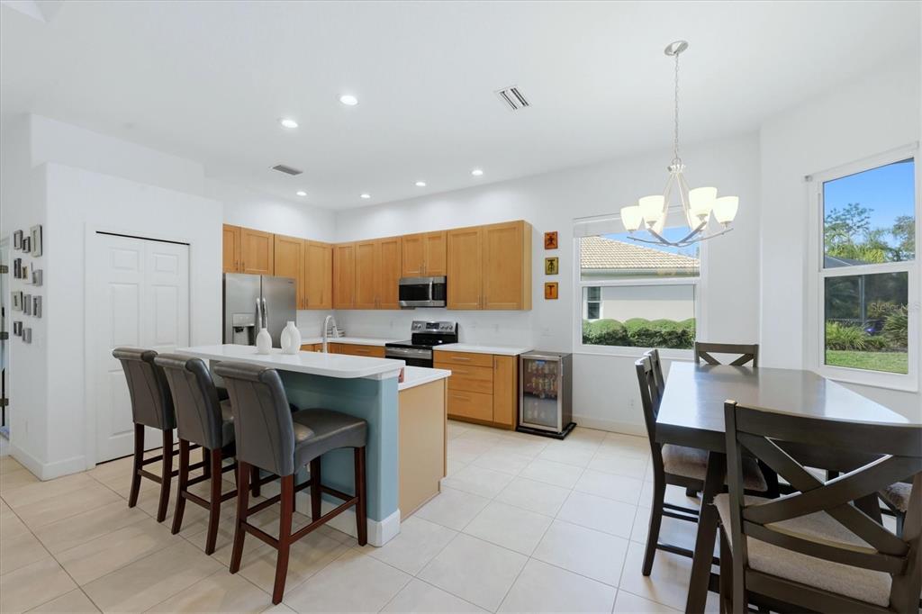 745 Fordingbridge Way Osprey, FL 34229 - Photo 11 of 53 a kitchen with a dining table chairs and white cabinets
