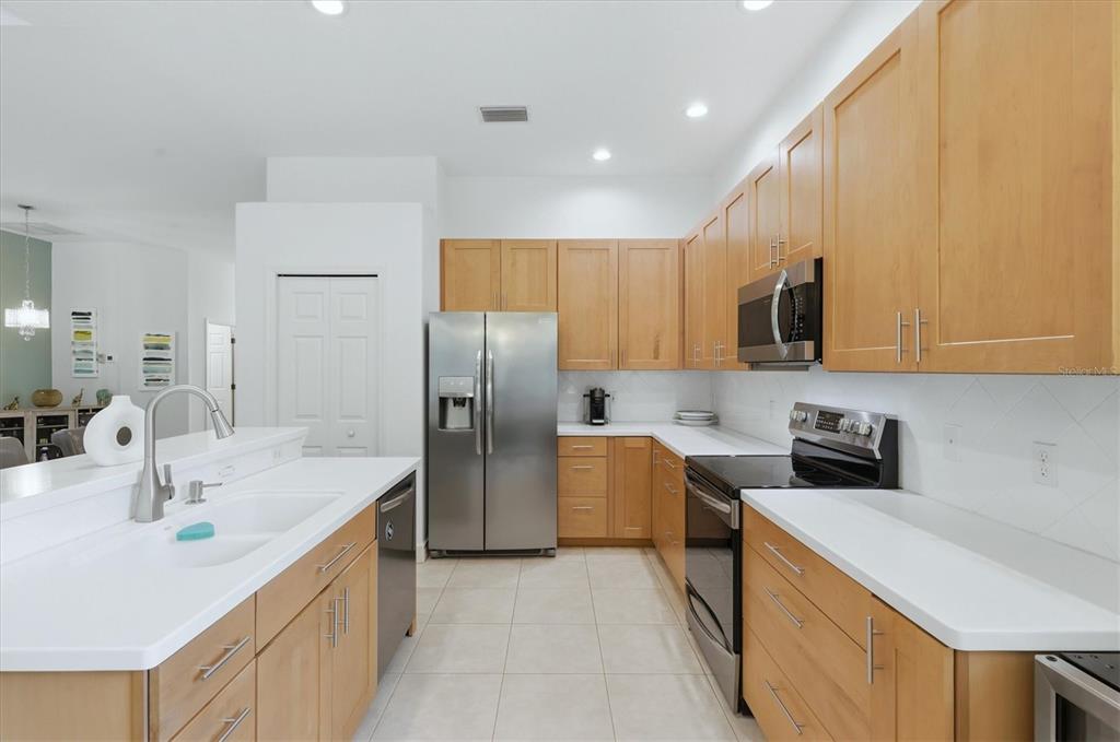 745 Fordingbridge Way Osprey, FL 34229 - Photo 13 of 53 a kitchen with stainless steel appliances a sink a refrigerator a stove a microwave and cabinets
