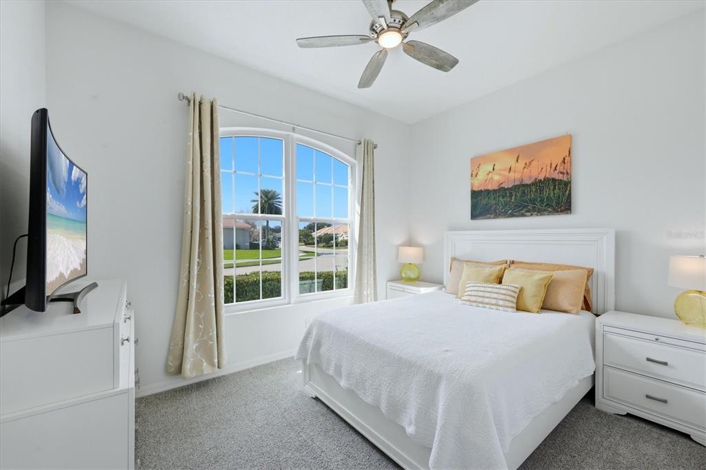 745 Fordingbridge Way Osprey, FL 34229 - Photo 24 of 53 a bedroom with a bed and a flat screen tv
