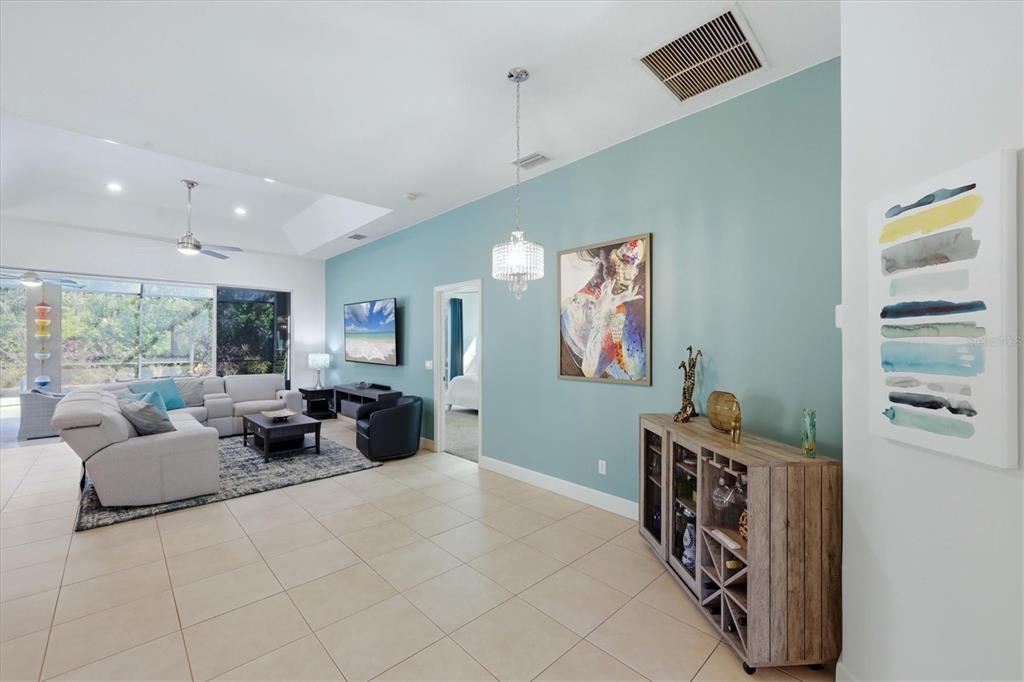 745 Fordingbridge Way Osprey, FL 34229 - Photo 4 of 53 a living room with furniture a large window and gym equipment