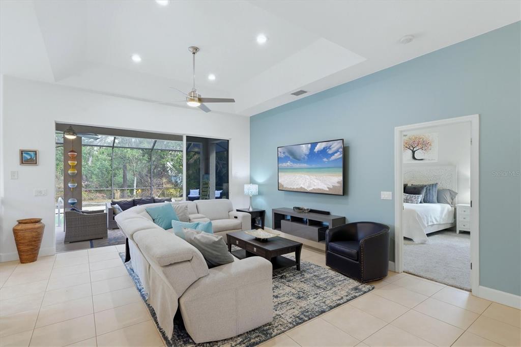 745 Fordingbridge Way Osprey, FL 34229 - Photo 5 of 53 a living room with furniture a large window and a chandelier