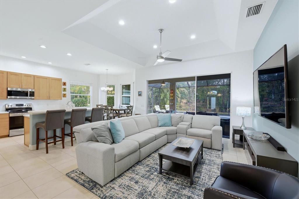 745 Fordingbridge Way Osprey, FL 34229 - Photo 7 of 53 a living room with furniture and a flat screen tv