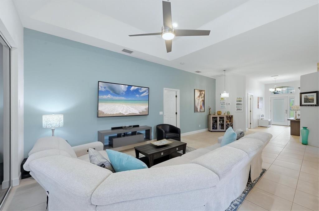 745 Fordingbridge Way Osprey, FL 34229 - Photo 8 of 53 a bedroom with bed a couch and a chandelier