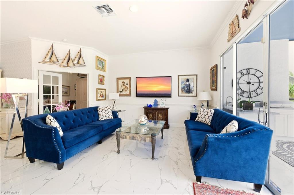 209 Countryside Drive Naples, FL 34104 - Photo 14 of 50 Living room with crown molding and marble finish floors