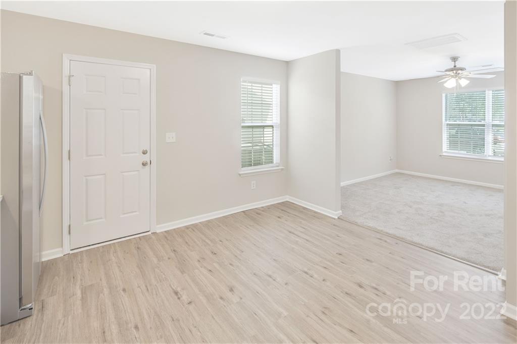 236 Pangle Drive Charlotte, NC 28217 - Photo 13 of 26 an empty room with wooden floor and windows