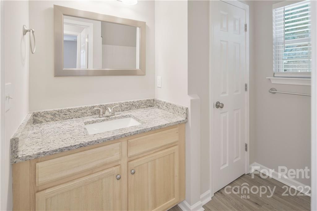 236 Pangle Drive Charlotte, NC 28217 - Photo 14 of 26 a bathroom with a granite countertop sink and a mirror