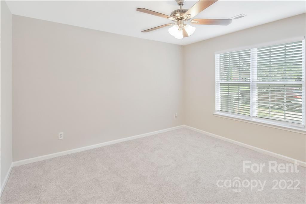 236 Pangle Drive Charlotte, NC 28217 - Photo 15 of 26 an empty room with a window and a fan
