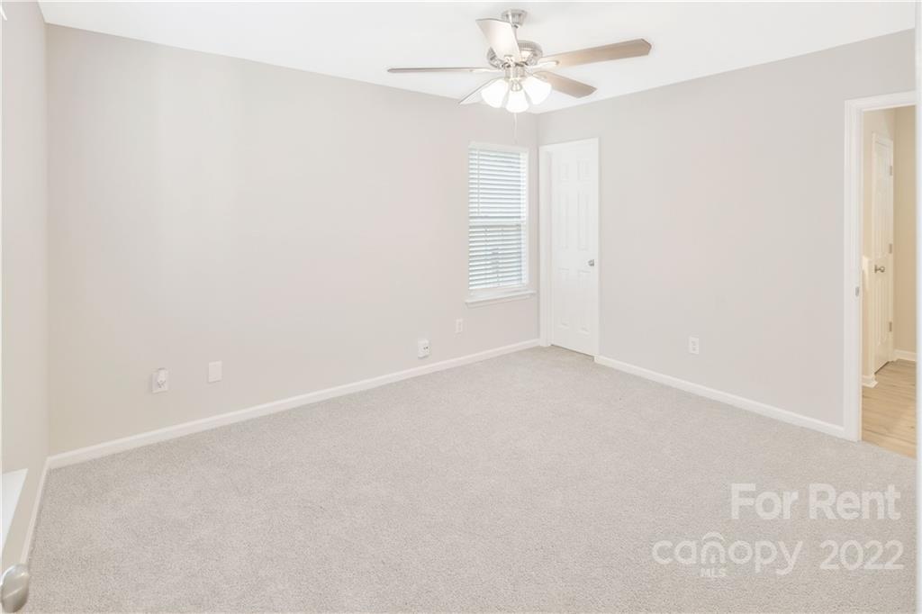 236 Pangle Drive Charlotte, NC 28217 - Photo 16 of 26 an empty room with a window and a fan
