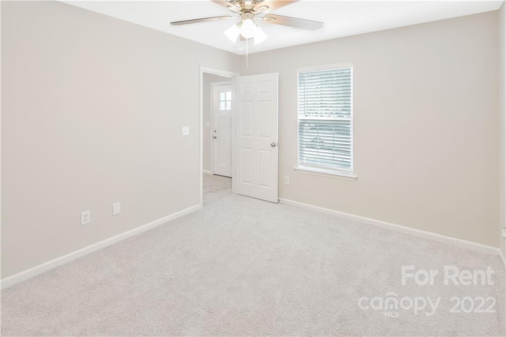 236 Pangle Drive Charlotte, NC 28217 - Photo 17 of 26 an empty room with windows and fan