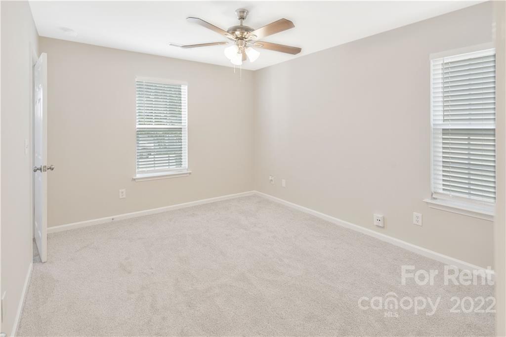 236 Pangle Drive Charlotte, NC 28217 - Photo 23 of 26 an empty room with windows and fan