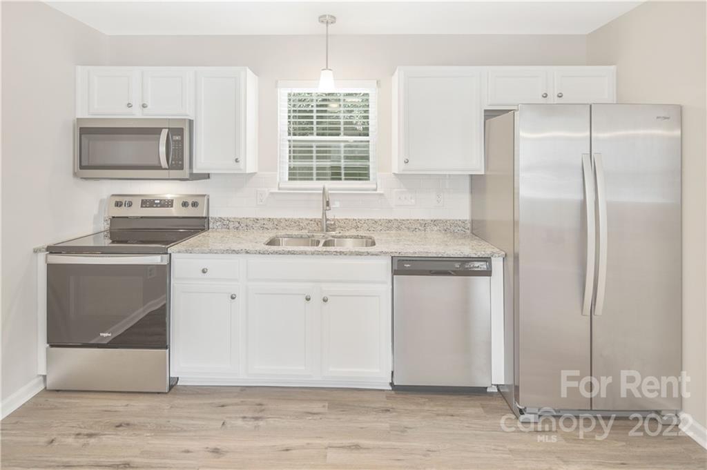 236 Pangle Drive Charlotte, NC 28217 - Photo 10 of 26 a kitchen with stainless steel appliances granite countertop a sink stove and refrigerator