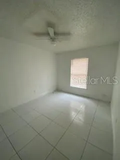 a view of an empty room and a window