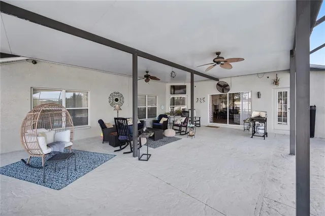 a view of a swimming pool with chairs in patio