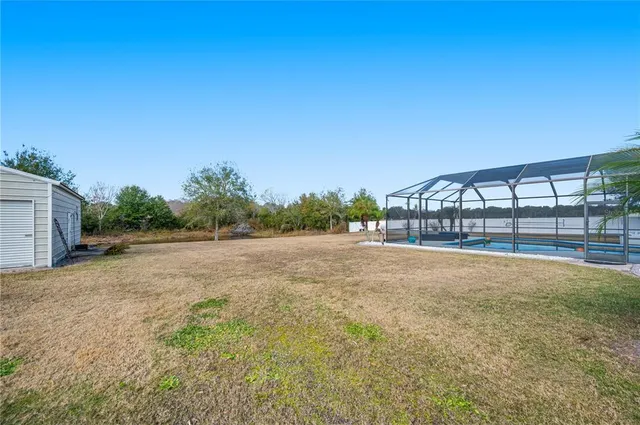 a swimming pool with outdoor seating and yard