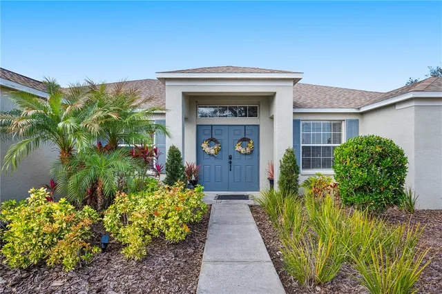 a work room with furniture a flat screen tv and a large window