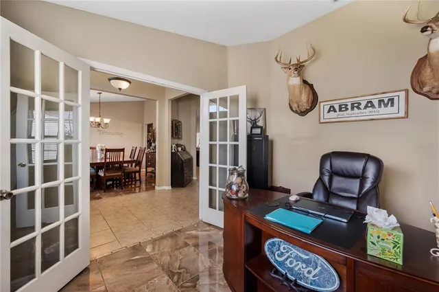 a dining room with furniture a chandelier and window