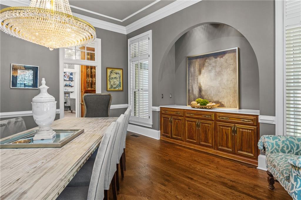 1940 Dinsmore Road Milton, GA 30004 - Photo 14 of 71 a dining room with wooden floor a chandelier a wooden table and chairs