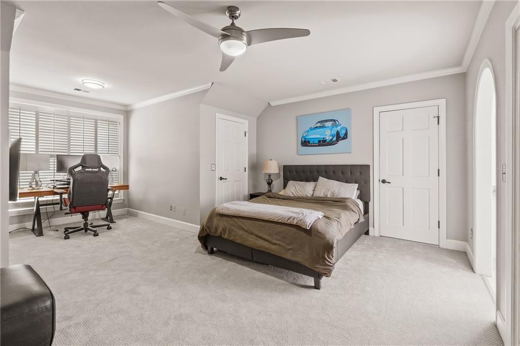 1940 Dinsmore Road Milton, GA 30004 - Photo 45 of 71 a spacious bedroom with a bed a table and a chair