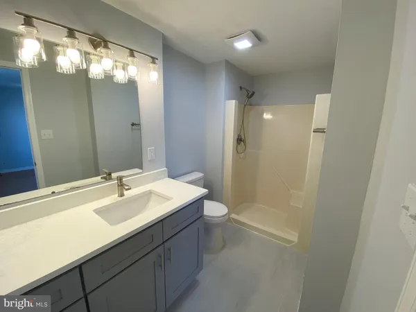 a bathroom with a sink a shower and a mirror