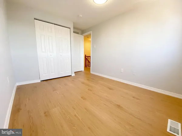 an empty room with a wooden floor and a window