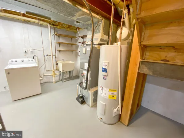 a view of a room with water heater and refrigerator